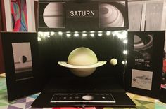 the saturn model is displayed in front of other space related items on display at an exhibit