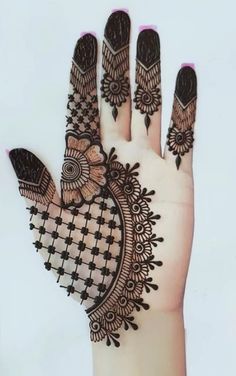 the hand is decorated with henna designs