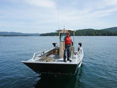 a man standing on top of a boat in the water