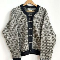 This L.L Bean cardigan sweater is a must-have for any woman's wardrobe. The ivory grey beige color is perfect for any occasion. It features long sleeves and is made of high-quality wool, ensuring both warmth and comfort.  The sweater is designed in a Nordic style, giving it a unique and elegant look.   The sweater is available in a size M and is perfect for regular size types. It is a women's department item and is suitable for any woman's clothing needs. The cardigan style is perfect for layering and can be worn with a variety of outfits. Chest: 48" Cream Wool Cardigan For Fall, Beige Long Sleeve Cardigan With Fair Isle Pattern, Beige Fair Isle Long Sleeve Cardigan, Beige Long Sleeve Fair Isle Cardigan, Vintage Beige Winter Cardigan, Vintage Gray Sweater For Fall, Classic Long Sleeve Cardigan With Fair Isle Pattern, Gray Vintage Sweater For Fall, Classic Long Sleeve Fair Isle Cardigan