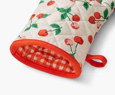 an oven mitt with cherries and gingham checkered fabric on it