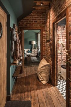 a hallway with wooden floors and brick walls