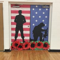 a door decorated with paper flowers and an image of a soldier standing in front of the american flag