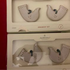 two white ceramic birds are in the packaging for each one's own item,