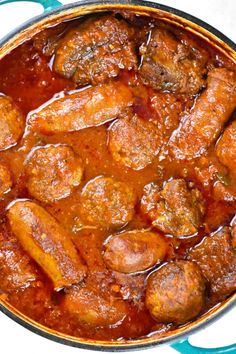 meatballs and sauce in a pot on a table