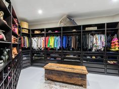 a walk in closet filled with lots of clothes