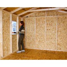 a woman standing in the corner of a room that is being built