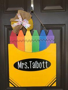 a door hanger decorated with crayons and the name mrs talbot