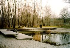 a park with benches and water in the middle