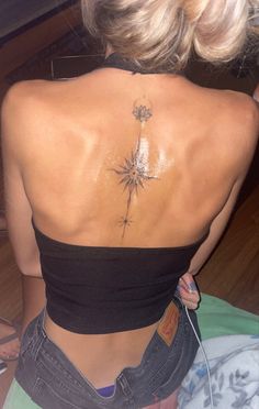 a woman with a tattoo on her back