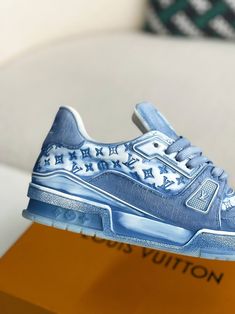 Step into iconic style with these LV Trainer-inspired sneakers reimagined in cool blue monogram denim. This contemporary take on a classic silhouette blends casual comfort with high-fashion appeal. The signature Louis Vuitton monogram adds a touch of understated luxury, while the clean lines and chunky sole create a versatile look that's perfect for everyday wear. Your order arrives in a branded shoe box, complete with dust bags, extra laces, socks, a care booklet, and a branded key holder. Trendy Denim Blue Sneakers For Streetwear, Blue Casual Sneakers With Embossed Logo, Designer Blue Sneakers For Spring, Blue Sneakers With Embossed Logo For Streetwear, Luxury Custom Blue Sneakers With Stitched Sole, Luxury Urban Custom Blue Sneakers, Luxury Urban Blue Custom Sneakers, Luxury Blue Sneakers For Streetwear, Blue Leather Sneakers With Logo Print