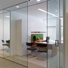 an office with glass walls and desks