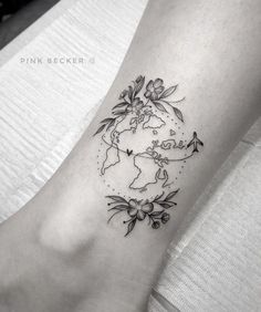 a black and white photo of a woman's foot with the world on it