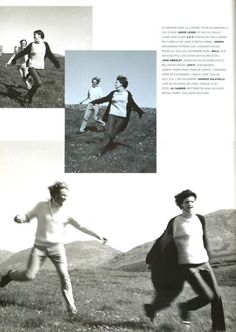 black and white photograph of people playing frisbee in the grass with mountains behind them