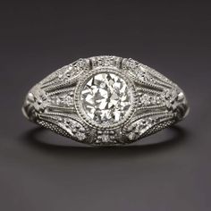 an antique style diamond ring with filigrees