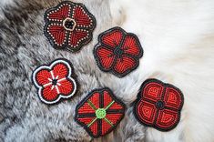 four red and black beaded appliques on fur