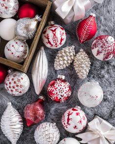 an assortment of christmas ornaments on a fur surface