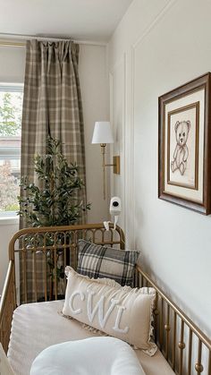 a bedroom with a bed, window and teddy bear on the wall in front of it