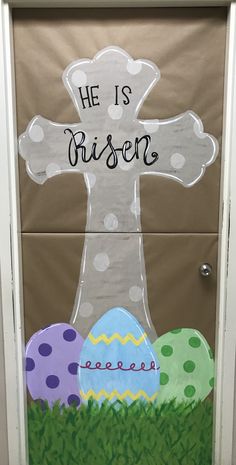 a door decorated with an easter decoration and the words he is risen written on it