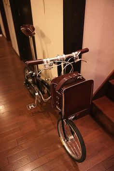 a bike with a basket is parked on the floor