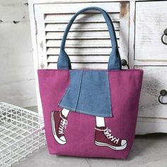 a pink and blue handbag with an image of a woman's feet on it