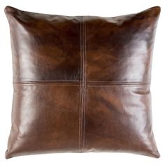 a brown leather pillow on a white background