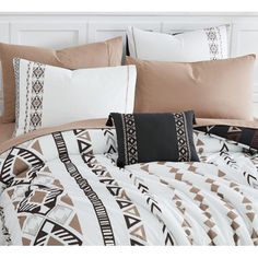 an image of a bed with pillows and blankets