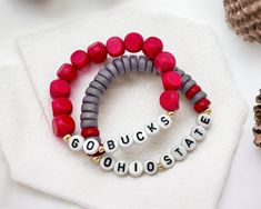 Red and Gray bracelets for Ohio State University! A great Graduation Gift for Buckeyes Game Day. A pair of bracelets with wood beads, size small, strung on stretch cord. ♥ All orders come wrapped and ready for gift-giving. These bracelets are Custom Made, which means they are FINAL SALE:) Please visit my shop for more customized jewelry! :) https://www.etsy.com/shop/ShopSweetClover Further Questions? Feel free to send a private message and let me know how I can help! XO! ~Shelli ShopSweetClover Ohio State Bracelet, Ohio State Jewelry, Big Little Basket, Kids Dishes, Gray Bracelet, Great Graduation Gifts, Customized Jewelry, Ohio State University, Ohio State Buckeyes