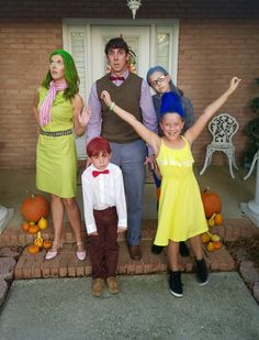 a group of people that are standing in front of a house