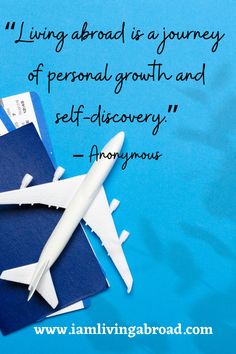 an airplane sitting on top of blue folders with a quote about living aboard is a journey of personal growth and self discovery