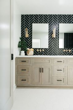 a bathroom with two sinks and mirrors in it