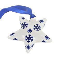 a white and blue ornament with snowflakes hanging from it's side