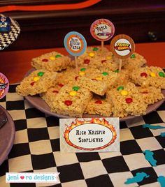 some rice krispy treats are on a table with other desserts and candies