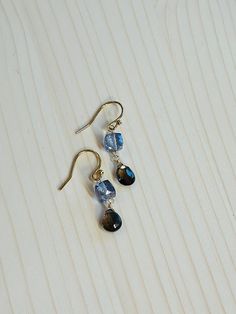 The Dusk Drop earrings are gold vermeil over sterling ear wires with a faceted cube of Mystic Blue Quartz and a teardrop Smokey Topaz stone. These dainty earrings measure approximately 1.25 inches long. Because these are faceted stones, they truly catch the light and have a striking sparkle in the sun. Natural stones may vary slightly in color. Shown in photos with the Eternity Choker-Gold Handcrafted in the USA. They will arrive wrapped, perfect for gift giving! Choker Gold, Smokey Topaz, Blue Quartz, Topaz Stone, Dainty Earrings, Topaz Gemstone, Ear Wires, Gold Vermeil, Natural Stones