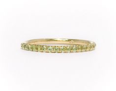 "Full Eternity Band Ring with U Micro Pave Set Natural Genuine Peridot. Material: Solid Gold (14K or 18K) Finish: High Polished /Shiny Fit: Comfort Fit (Rounded Interior) Width: 1.8 mm Height: 1.8 mm Setting Type: U Micro Pave (Reminds the letter\"U\") Stone: Natural Green Peridot Cut & Shape: Round, Diamond Cut Total Carat Size: apx 0.70+ ct Quantity of Stones: apx 38 (Varies by ring size) Quality: AAA Peridot has a unique shade of lime green that looks different green depending on inside/o Yellow Gold Peridot Stackable Rings For Wedding, Yellow Gold Stackable Rings With Peridot, Yellow Gold Peridot Stackable Rings For Anniversary, Stackable Yellow Gold Peridot Jewelry, Yellow Gold Peridot Stackable Rings, Guard Ring, Push Present, Birthstone Stacking Rings, Mothers Ring