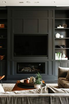 a living room filled with furniture and a flat screen tv mounted on the wall above a fireplace