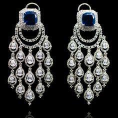 Opt for luxurious modernity! Extravagant chandelier earrings with glimmering CZ stones and an emerald/sapphire accent. Approximate earrings length is 3". Designed over a high quality brass as base metal. Made by order. Kindly allow 4-6 weeks for the delivery of this item. For custom or urgent requests, please contact support@alacouture.com. *Please Note: We use faux stones and beads in all of our jewelry. Earrings Sapphire, Faux Stone, Bride Jewellery, Gold Polish, Sapphire Gemstone, Cz Stone, Base Metal, Chandelier Earrings, Wedding Jewelry