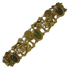 THIS IS A SUPERB RARE JADE ART NOUVEAU BELLE EPOQUE BRACELET WITH 6 EXTRAORDINARY NATURAL ANTIQUE JADE CABOCHONS OF INCREDIBLE BEAUTY SET IN A 14 KARAT GOLD ART NOUVEAU SETTING WITH FULLY MODELED THREE-DIMENSIONAL PANSY FLOWERS WITH PEARL ACCENTS IN AN OPEN WORK LINK BRACELET DATING TO THE BELLE EPOQUE TO ART NOUVEAU PERIOD - C1880-1910 - A MUSEUM QUALITY JEWEL! The Art Nouveau jewels are so very rare and so desirable. And here we have one with the most stunning natural Jade. The 6 Jade cabochon Pansy Flowers, Bijoux Art Nouveau, Antique Jade, Pansy Flower, Pansies Flowers, Natural Jade, Jade Stone, Gold Art, Flower Bracelet