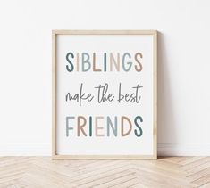 a wooden frame with the words siblings make the best friends on it, against a white wall