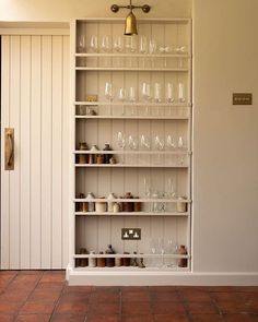 an empty shelf with wine glasses on it