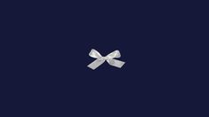 a white bow on a dark blue background