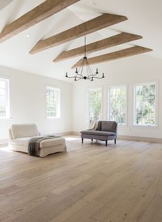 an empty living room with white walls and wood floors