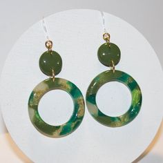 "If you're looking for statement earrings to dress up an outfit, this pair is for you! Handcrafted from polymer clay with shades of green and hints of gold, this one of a kind pair is topped off with a resin finish to give them a classy shine.  2.5\" drop length Made with plastic hooks that are perfect for people with sensitive ears or metal allergies. Other pieces of the earring may be metal but do not touch the earlobe. Due to the color differences in computer monitors the colors might be slig Small Drawstring Bag, Green Gift, Fall Earrings, Earrings Metal, Plastic Hooks, Green Gifts, Free Post, Sensitive Ears, Computer Monitors