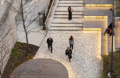 several people are walking up and down the stairs