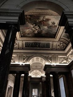 the ceiling is decorated with paintings and columns