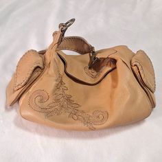 Beautiful Used Condition/Not Nwt Cole Haan Boho Handbag Heavy Embroidery And Stitching On Pebbled Tan Leather. Flap Over Magnetic Closure,One Inside Zip Pocket With A Large Open Well. Tan Interior Heavy,Sturdy Hardware. Two Outside Magnetic Closure End Pockets. Measures Approx 15" X 8" X 9" #Colehaan. Beige Leather Handheld Hobo Bag, Handheld Beige Leather Hobo Bag, Vintage Beige Leather Hobo Bag, Cream Leather Pouch Hobo Bag, Cream Leather Hobo Bag, Boho Handbag, Hobo Tote Bag, Boho Handbags, Brown Leather Satchel