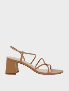 Striking a delicate balance between formal and casual styles, these Meadow sandals are a refreshing take on the classic strappy sandals. The distinctive interlaced design features swooping lines that create a dynamic and visually interesting silhouette. With a wearable camel finish, this pair is versatile enough for everyday wear. Pair it with a maxi dress for a dinner date, or a casual everyday uniform of t-shirt and jeans - either way, the block heels will add a flattering lift to your frame. Formal Sandals With Multiple Straps And Open Heel, Casual Strappy Sandals For Evening, Casual Strappy Evening Sandals, Spring Sandals With Multiple Straps And Open Heel, Brown Strappy Sandals For Evening, Beige Strappy Sandals With Padded Heel, Brown Strappy Evening Sandals, Elegant Brown Strappy Slingback Sandals, Brown Strappy Slingback Sandals For Spring