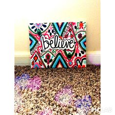 a colorful painting with the word believe painted on it's side in black and white