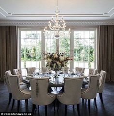 a dining room table with chairs and a chandelier