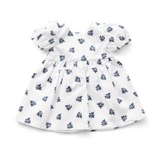 a white dress with blue leaves on the front and bottom, it's short sleeves